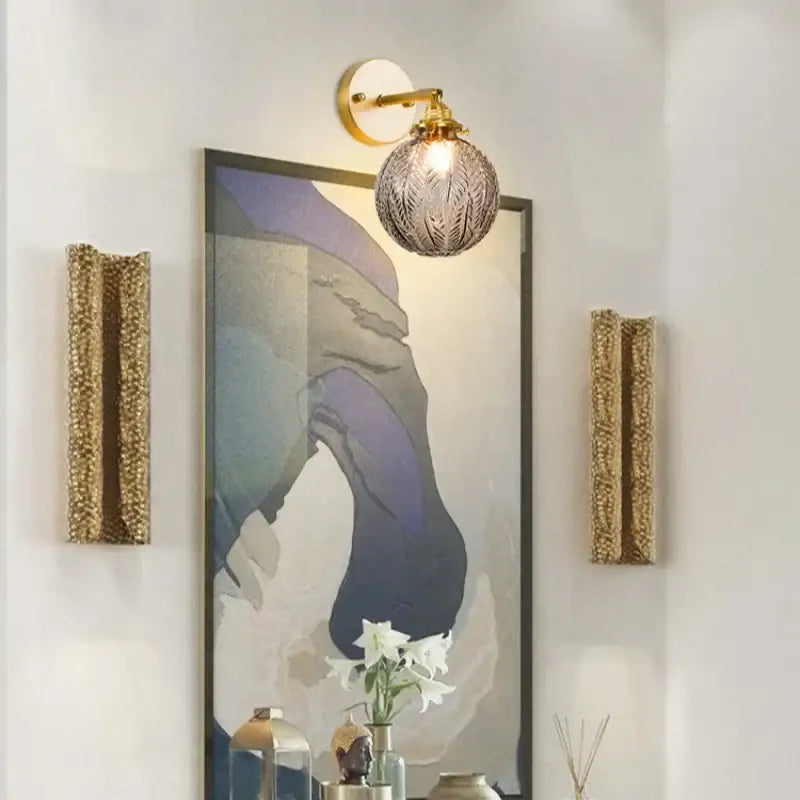 Vintage etched grey glass led wall lamp with textured spherical glass and brass-finished metal arm for decorbites grey glass sconce