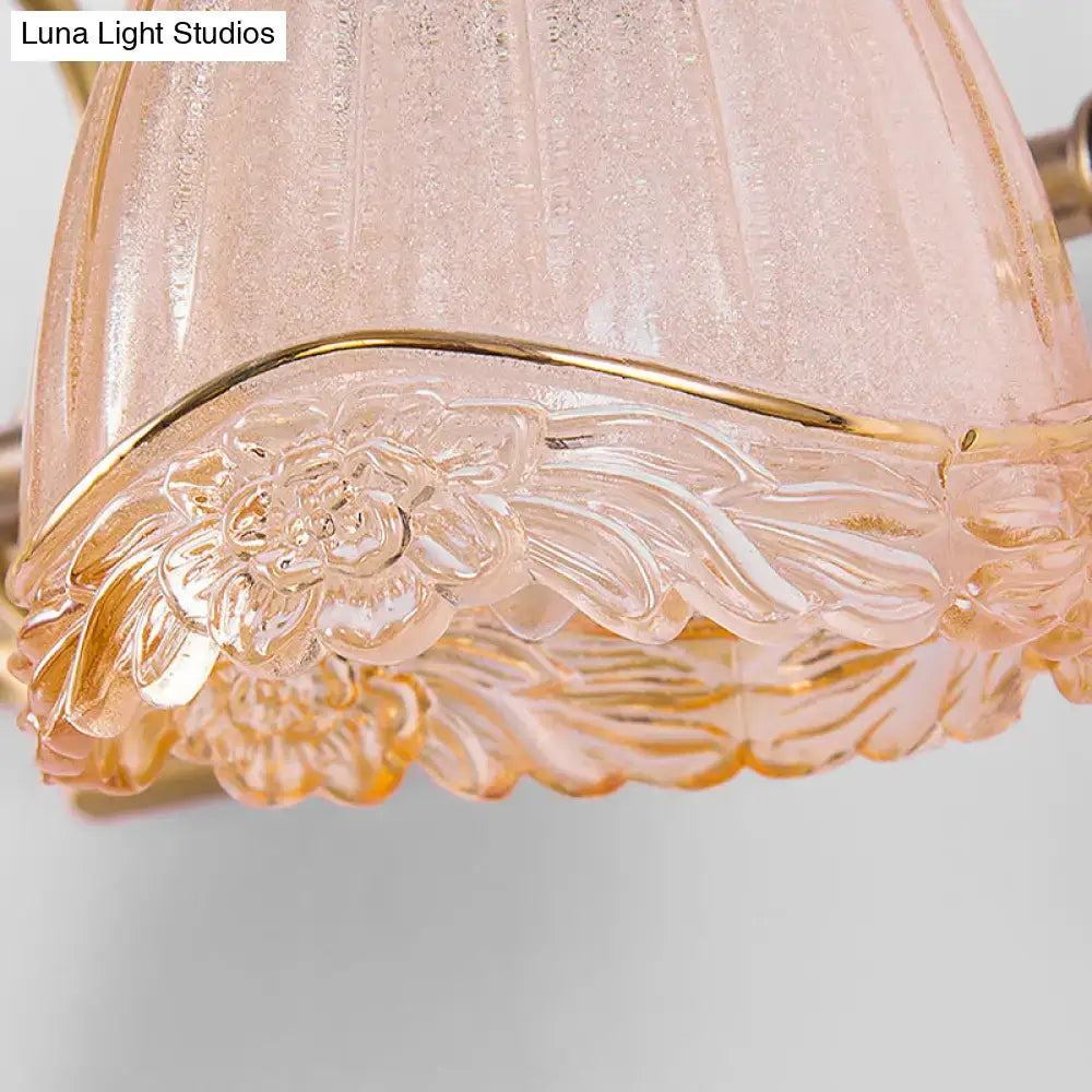 Vintage floral amber glass wall sconce with delicate pink frosted glass lampshade and gold-toned trim for bedroom use