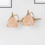 Pair of vintage wall sconces featuring gold-toned metal and amber glass shades with intricate floral etching