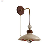 Vintage floral ceramic led wall light with cream shade, dark wood mount, brass accents, and pull chain switch for bedroom decorbites ceramic led wall