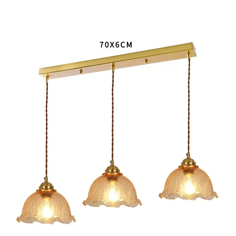 Gold-toned brass pendant light with three amber cracked glass shades and twisted brown cords for vintage decorbites cracked glass collection