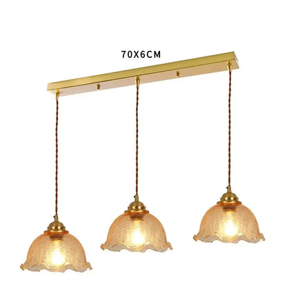 Gold-toned brass pendant light with three amber cracked glass shades and twisted brown cords for vintage decorbites cracked glass collection