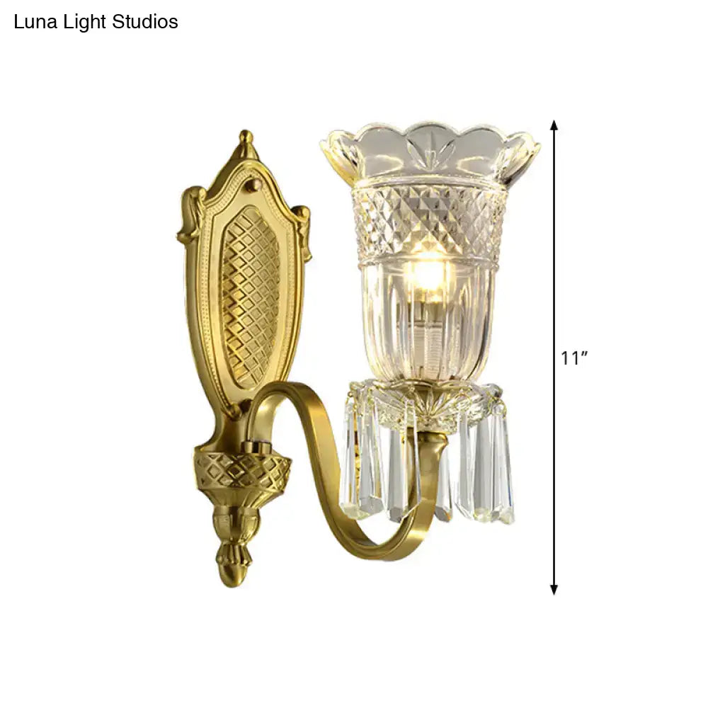 Gold-finished vintage floral wall light with ornate design, faceted crystal glass shade, and dangling crystal accents