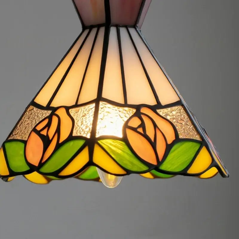 A warm-toned vintage floral stained glass pendant light with orange roses and green leaves for decorbites colorful flower decor