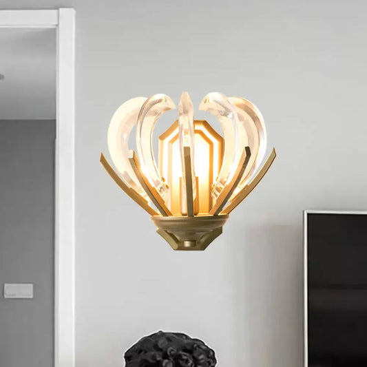 Gold finish vintage flower wall light with clear curved glass petals and a central geometric light source for bedroom use
