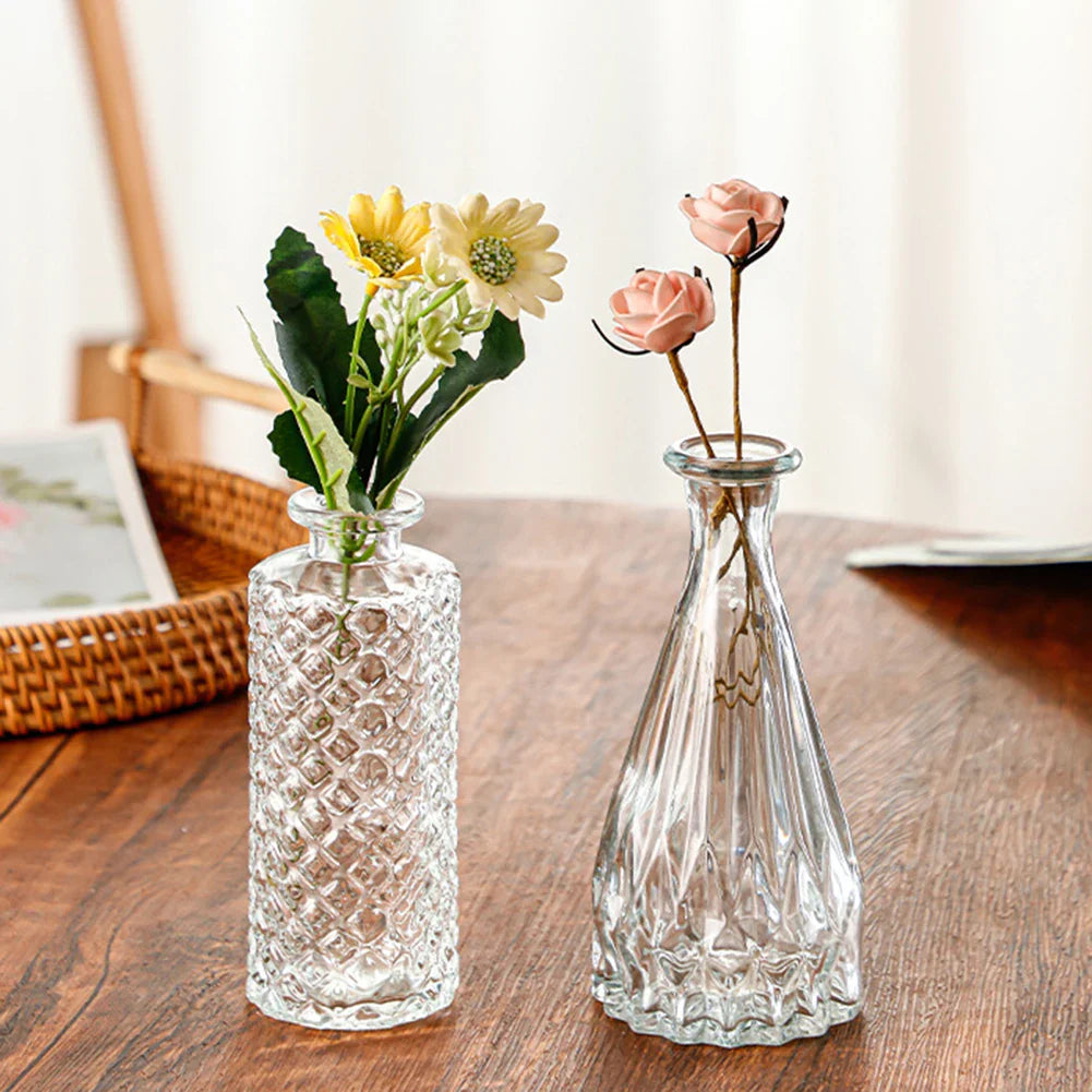 Two clear glass vases with textured surfaces holding artificial flowers ideal for vintage pot decor and plant pot decor
