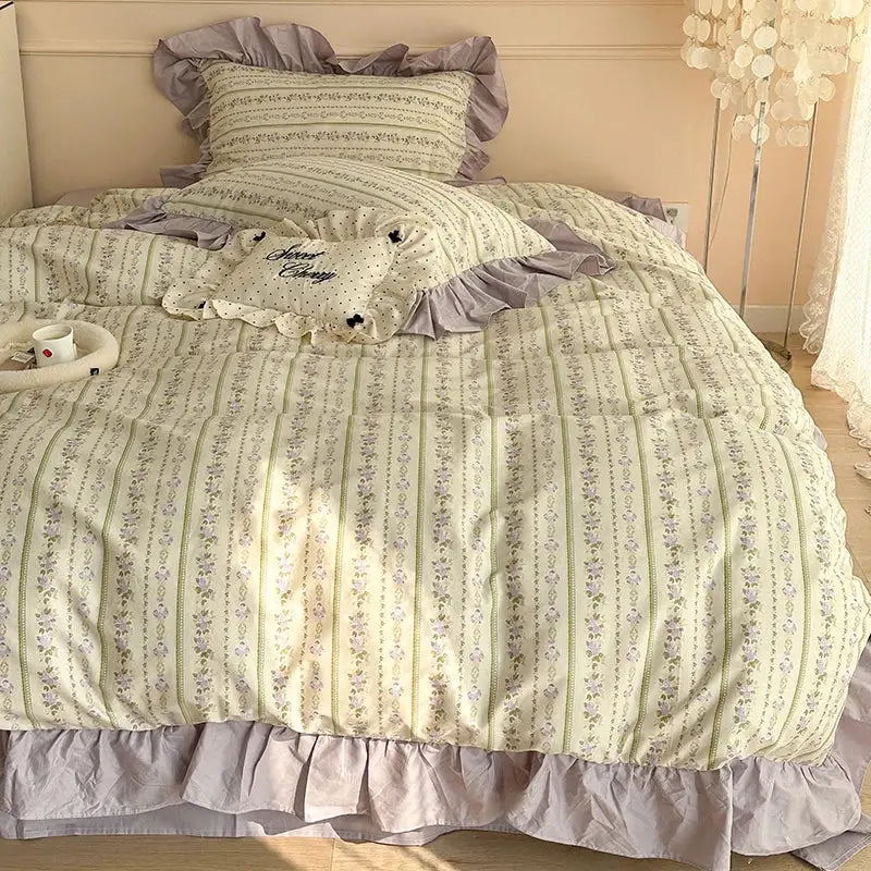 A cream quilted french floral cotton bedding set with green stripes lavender embroidery and muted purple ruffled edges