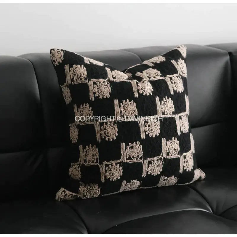 Black cushion cover featuring intricate beige embroidered sunflower patterns for decorative bedroom use