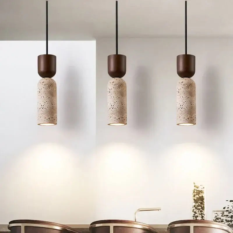Three vintage french pendant lights with matte brown tops and beige stone terrazzo bodies for dining room use
