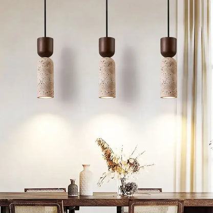 Three vintage french pendant lights with matte brown tops and speckled stone terrazzo bodies for dining room use