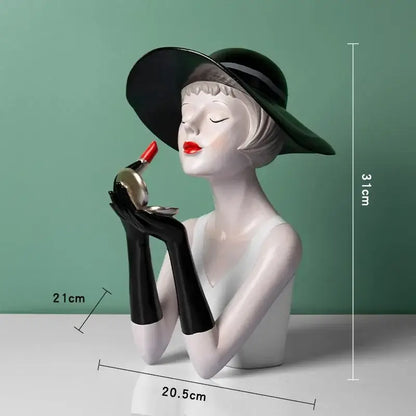 A glossy white resin vintage glamour bust wearing a black hat and gloves holding red lipstick for living room decorbites elegant decor