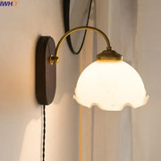 Vintage glass copper led wall lights with brass curved arm, off-white frosted glass shade, and wood backplate for bedroom