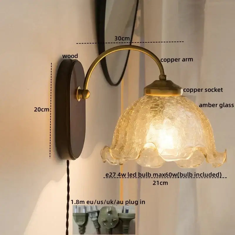 Antique brass-finished copper led wall light with textured amber glass shade and wooden backplate for bedroom use