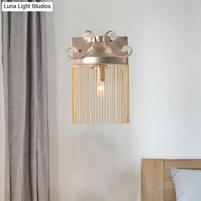Vintage gold aluminum tassel wall light with crystal accents and cascading chains for elegant bedroom wall light fixture