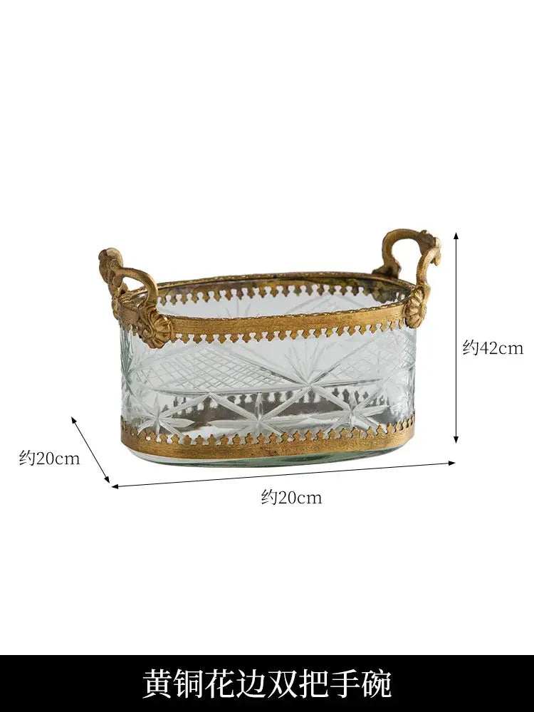 An elegant vintage gold snack plate storage box with carved glass and ornate gold brass handles and borders