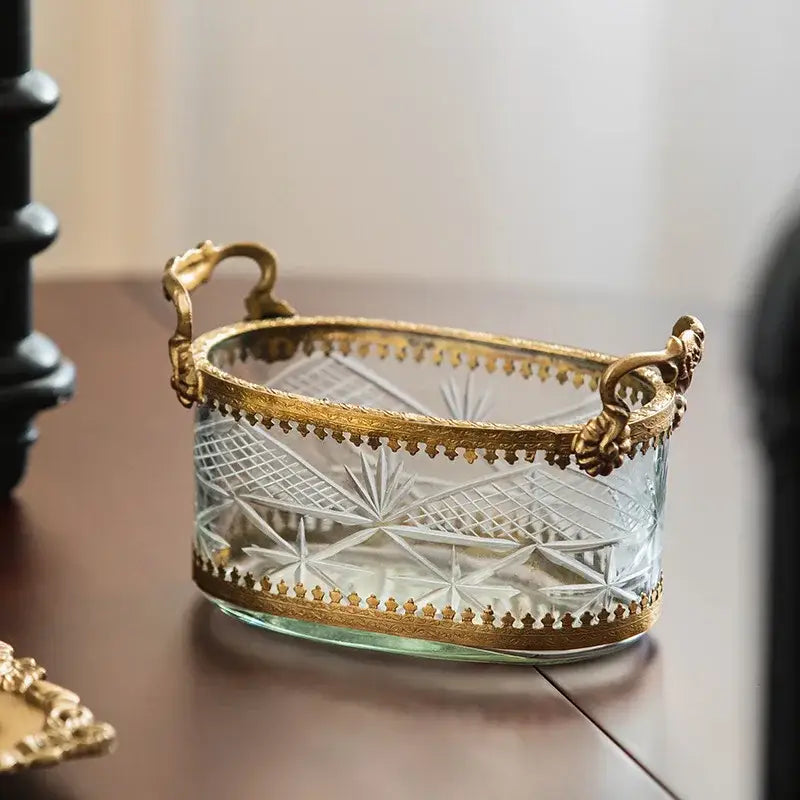 Vintage gold and carved glass snack plate with intricate crystal patterns and ornate metal handles as a storage box