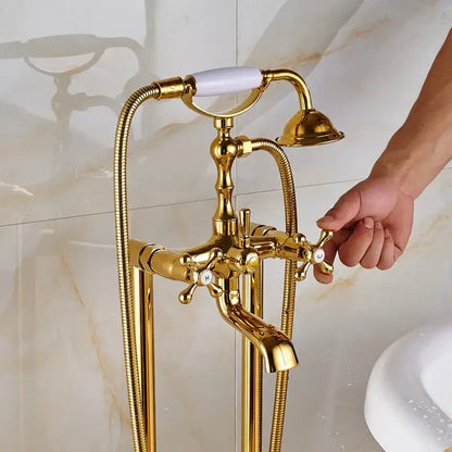 Vintage gold bath mixer tap with white ceramic handle cross-shaped knobs and handshower on flexible braided hoses