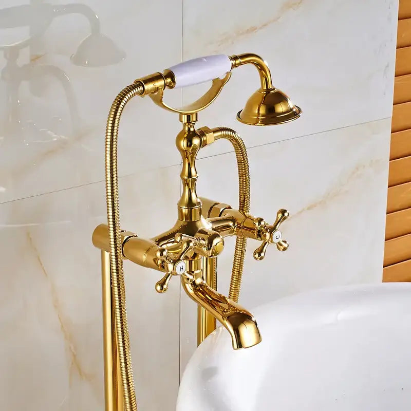 Vintage gold bath mixer tap with white ceramic handle and cross-shaped knobs for elegant bathroom fixtures