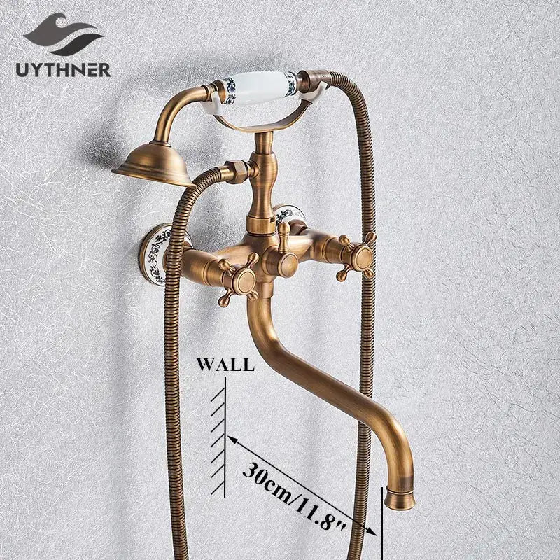 Antique brass vintage-style wall-mounted golden black bathtub faucet with ceramic handles and decorbites floral patterns