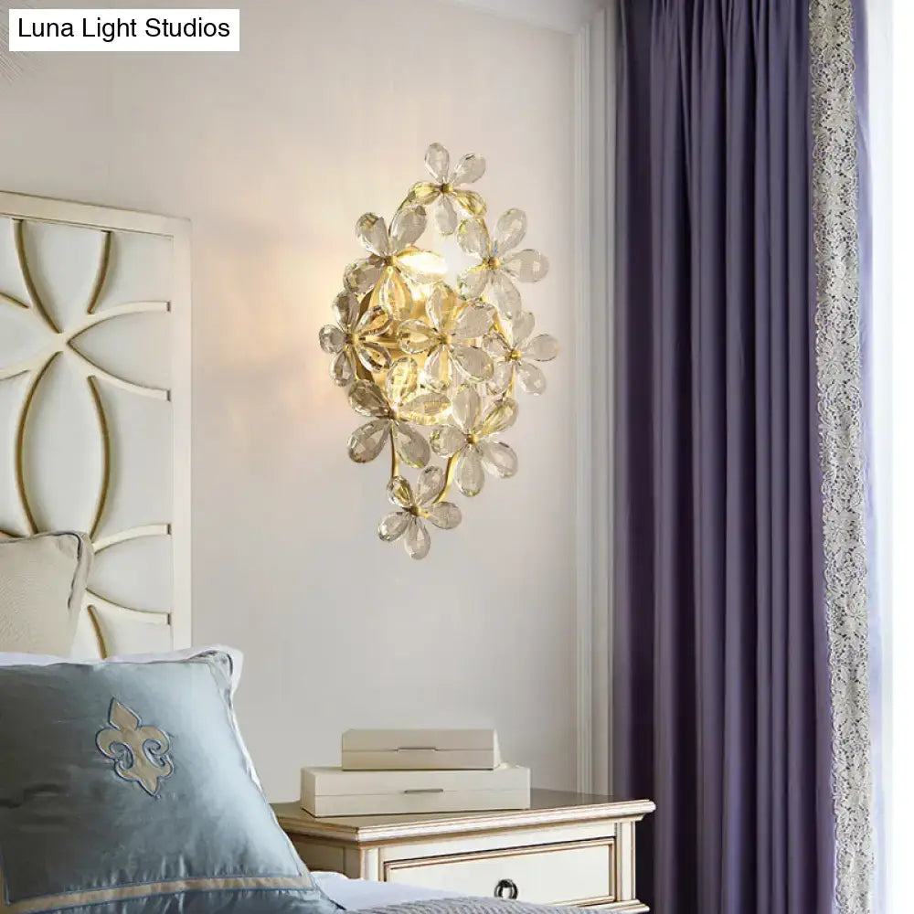 Vintage gold crystal flower wall sconce with translucent glass petals in a cascading cluster for bedroom light
