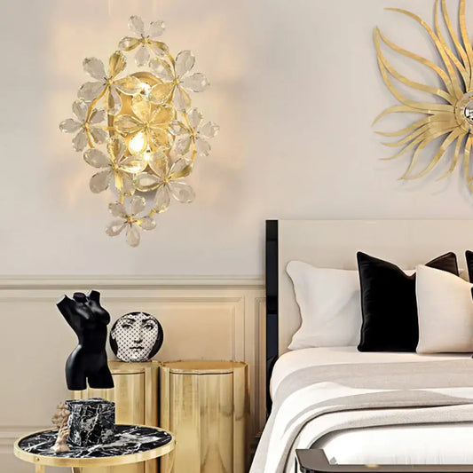 Vintage gold crystal flower wall sconce with clear flower-shaped crystal accents for elegant bedroom light