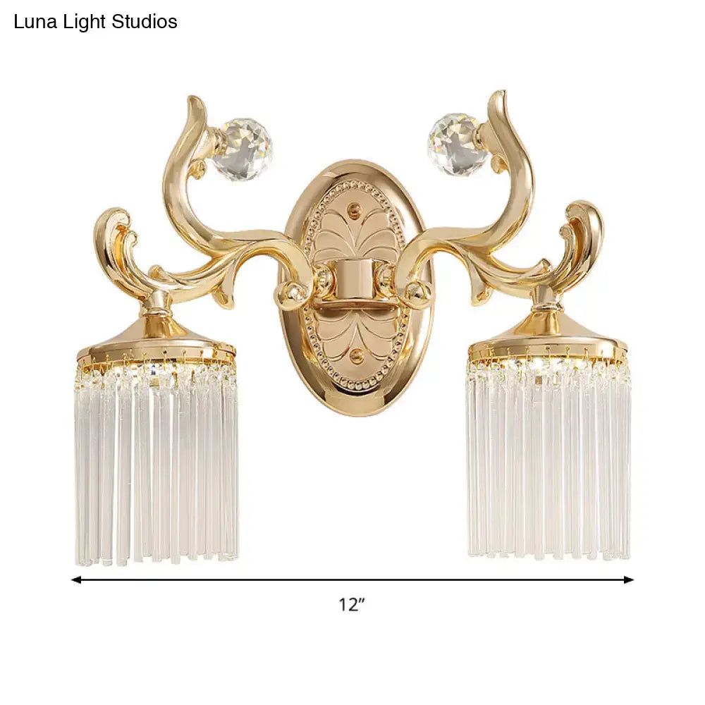 Vintage gold wall mounted light with ornate design clear pipe shades and decorative crystal accents for bedroom use