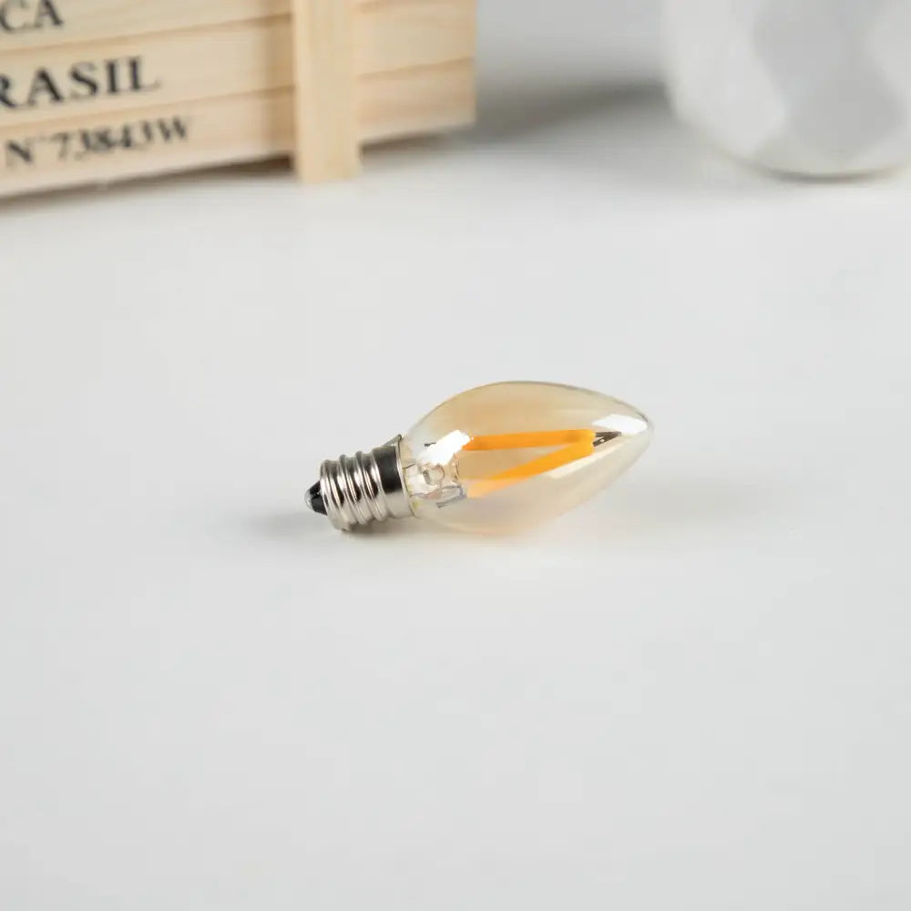 Clear glass vintage gold dimmable led filament edison candle light bulb with warm orange filament and silver base
