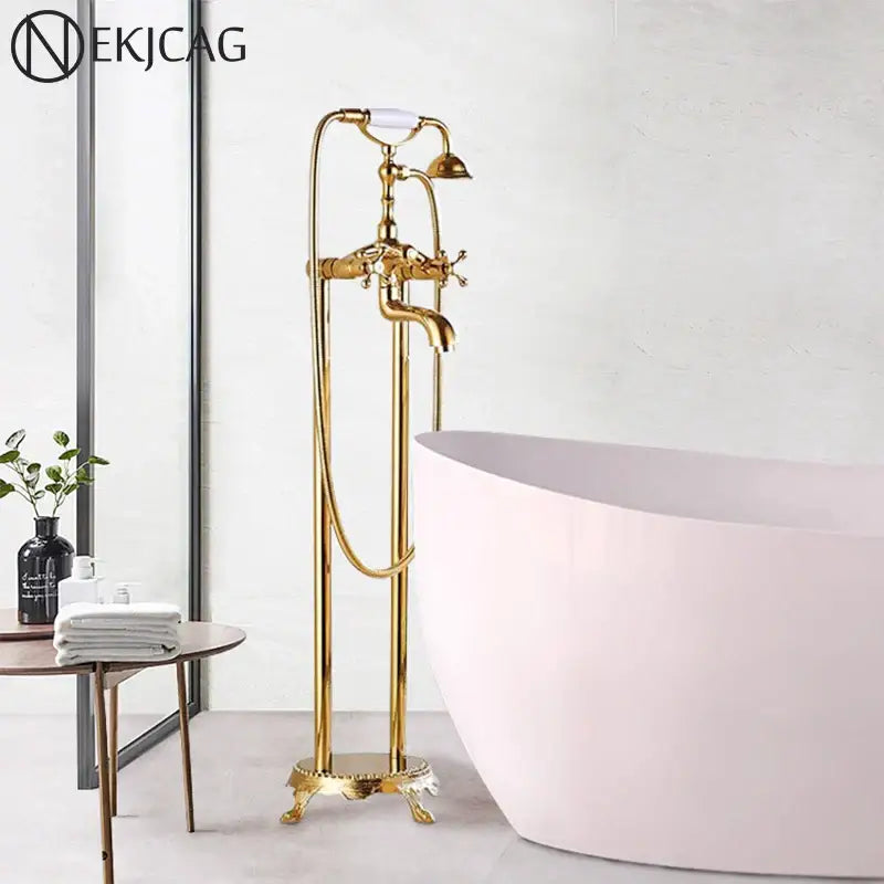 Vintage gold dual handle clawfoot bathtub shower faucet with white ceramic handles and ornate detailing for bathroom use
