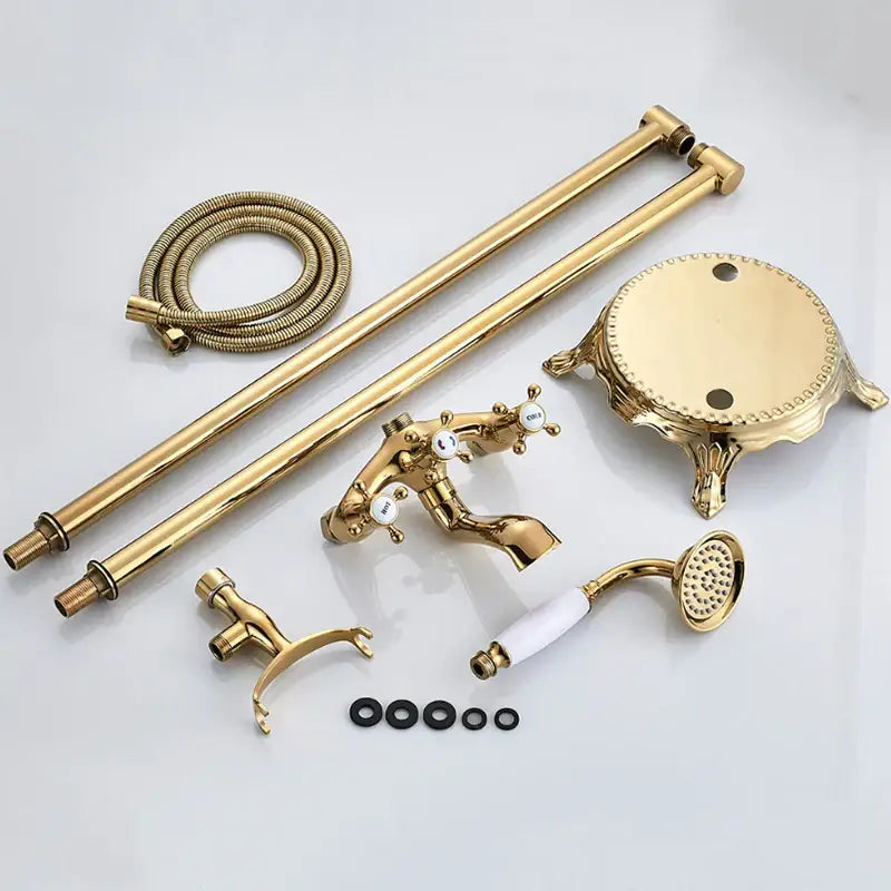 Vintage gold dual handle clawfoot bathtub shower faucet set in brass with ornate detailing and white ceramic handles
