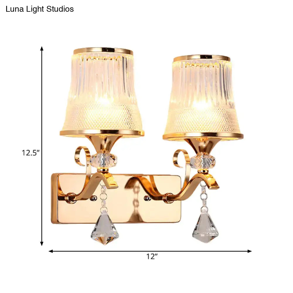 Vintage gold finish wall lamp featuring clear glass fluted shades and crystal teardrop pendants for bedroom use