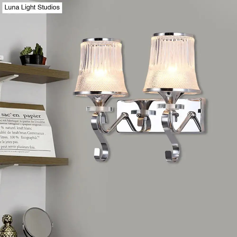 Chrome-finished double-arm wall lamp with textured translucent clear glass shades and vintage gold finish for bedroom use