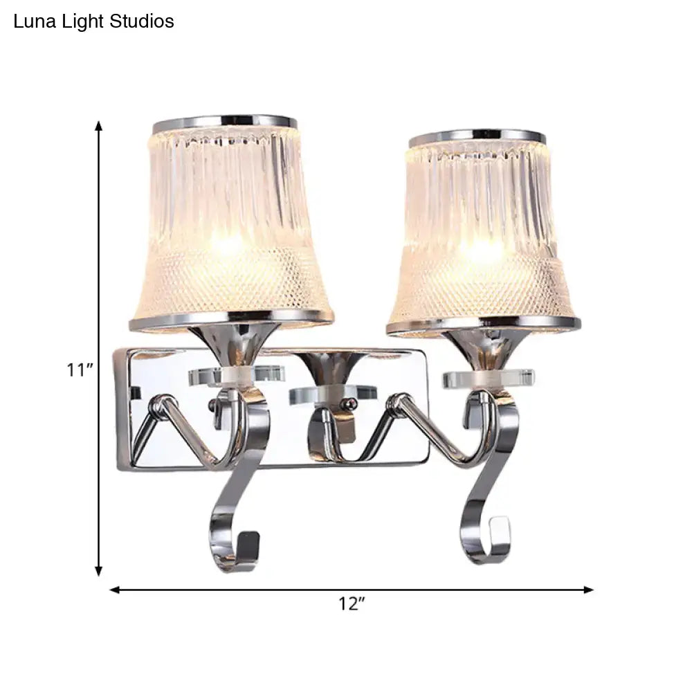 Chrome finished wall lamp with two textured clear glass shades for elegant bedroom lighting