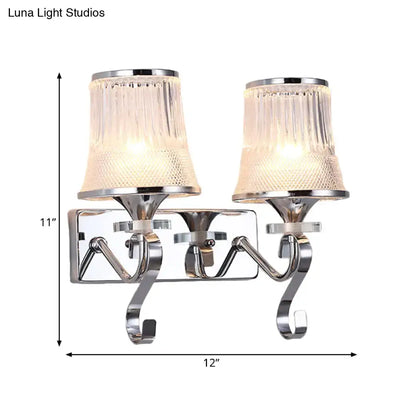 Chrome finished wall lamp with two textured clear glass shades for elegant bedroom lighting