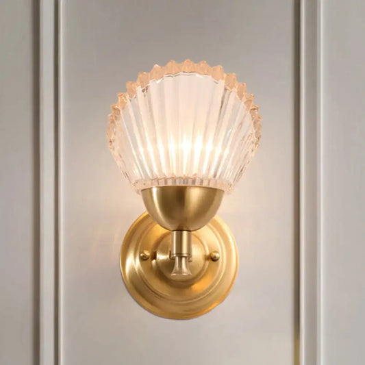 Vintage wall lamp with gold finish metal base and frosted glass seashell-shaped shade for bedroom lighting