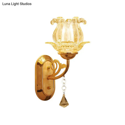 Vintage gold flower wall sconce featuring a golden brass frame with amber glass shade and crystal teardrop pendant