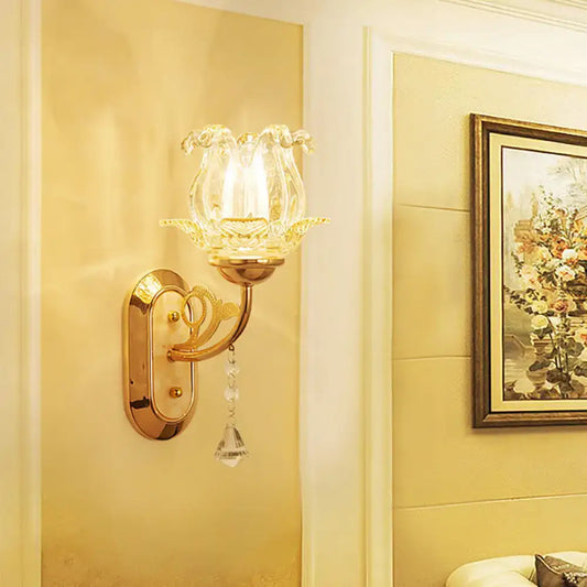 Vintage gold flower wall sconce with amber glass shade and pull chain featuring a clear hand-blown flower design