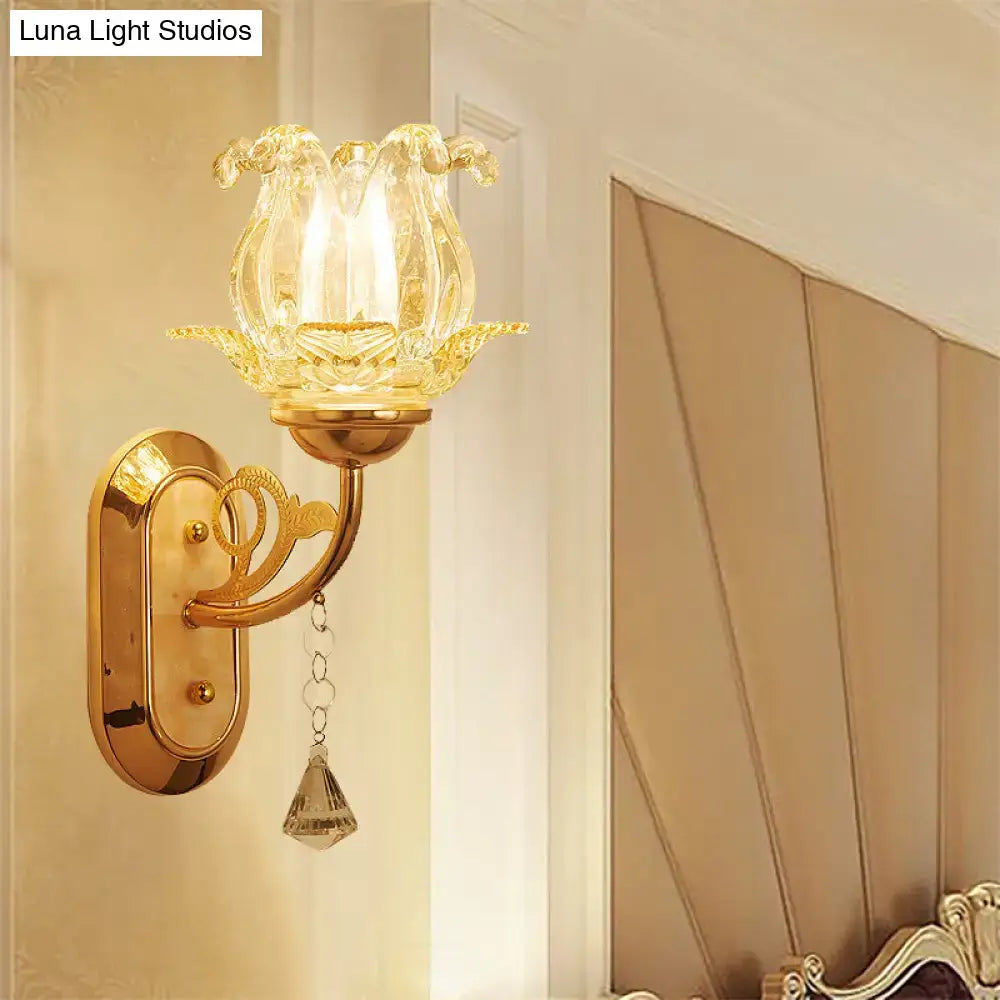 Vintage gold flower wall sconce with amber glass shade featuring faceted glass and a dangling crystal pendant