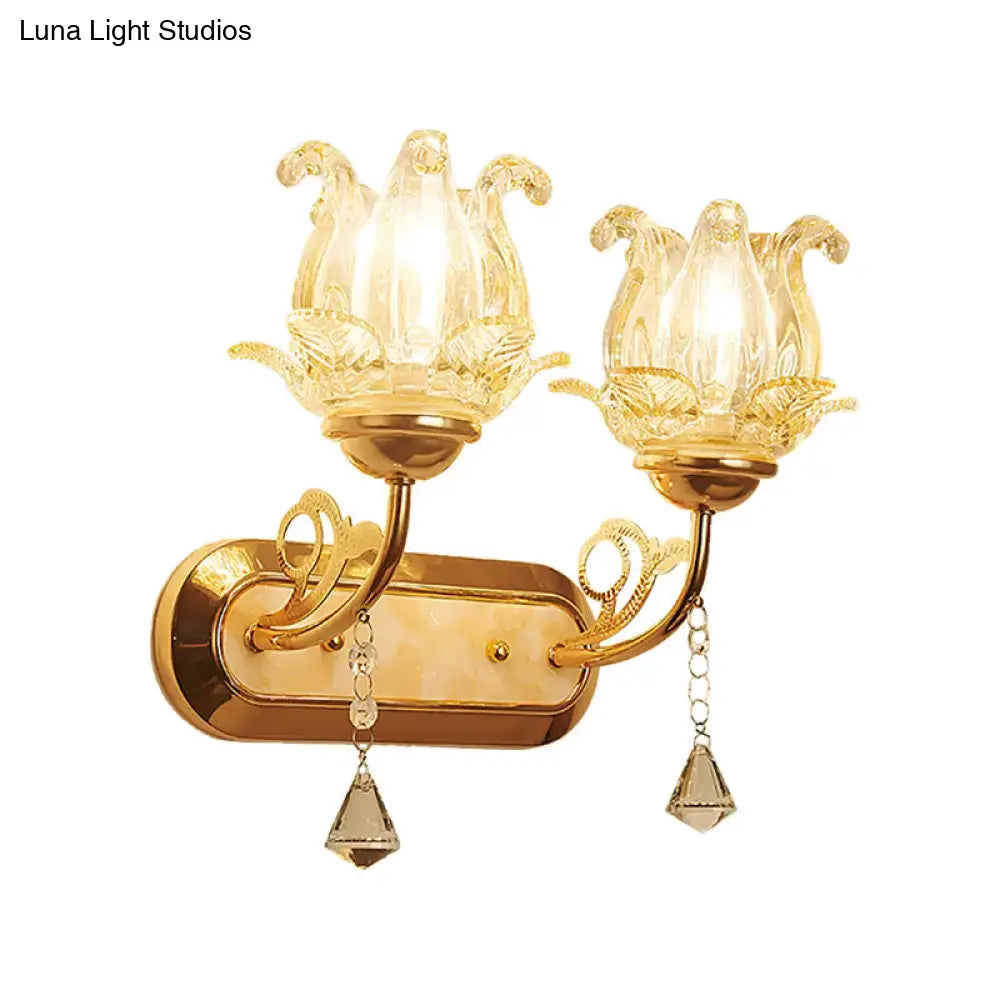 Vintage gold flower wall sconce with amber glass shade, pull chain, and crystal teardrop pendants for bedroom lighting