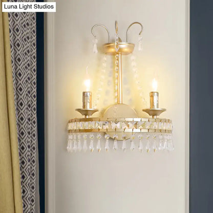 Vintage gold metallic exposed wall lamp featuring two candle-style lights with clear crystal droplets for hallway use