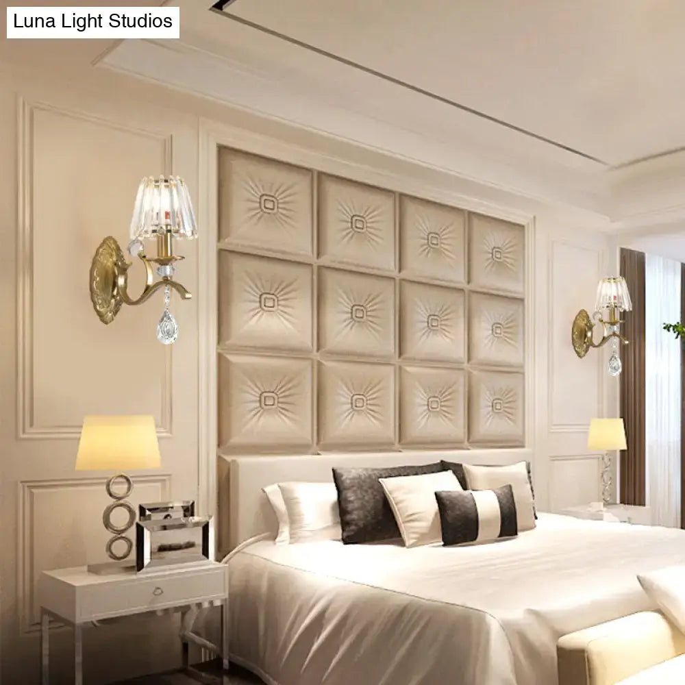 Beige tufted leather headboard with sunburst pattern complementing vintage gold metallic wall lamp crystal sconce