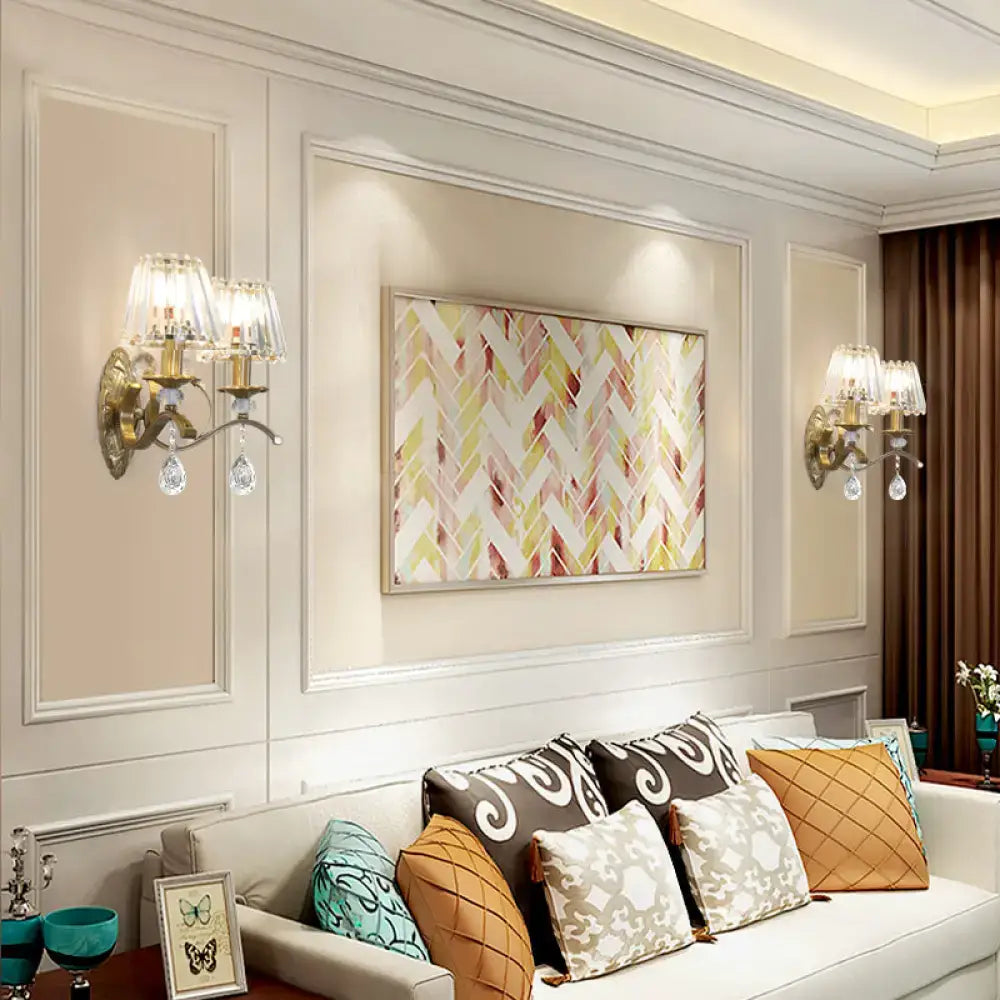 A rectangular framed artwork with a modern abstract design complements the vintage gold metallic wall lamp crystal sconce
