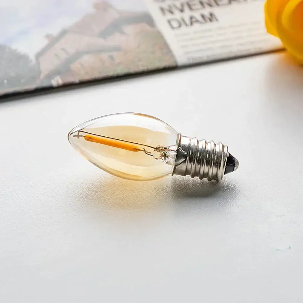 Clear glass filament vintage gold tint glass led candelabra bulb with warm amber glow and metallic screw base for decorbites gold tint