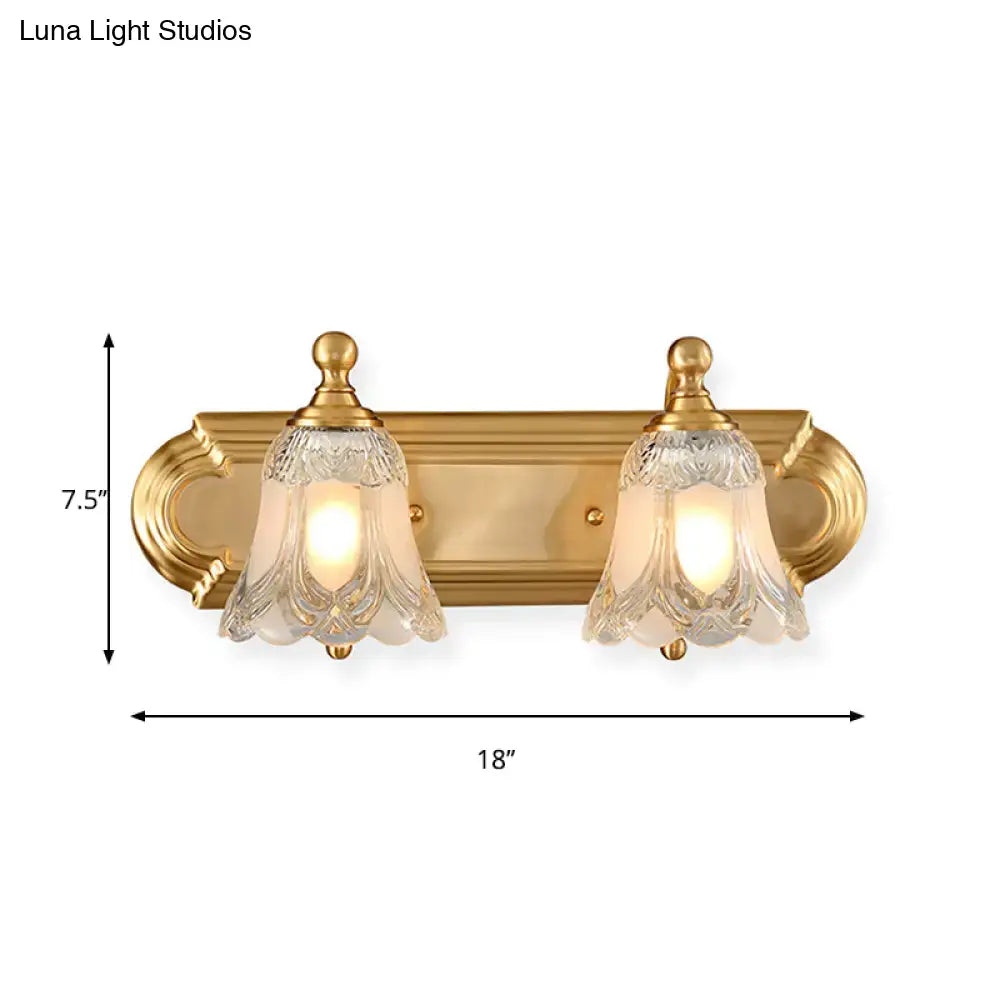 Vintage gold wall light with two ornate clear glass shade bell-shaped fixtures for bathroom vanity lighting
