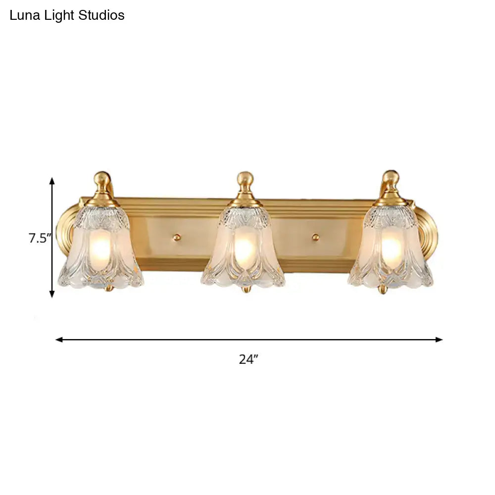 Vintage gold wall light bathroom vanity fixture with clear glass shade and gold-toned bell-shaped shades