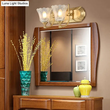 Vintage gold wall light with three frosted clear glass shades for bathroom vanity lighting