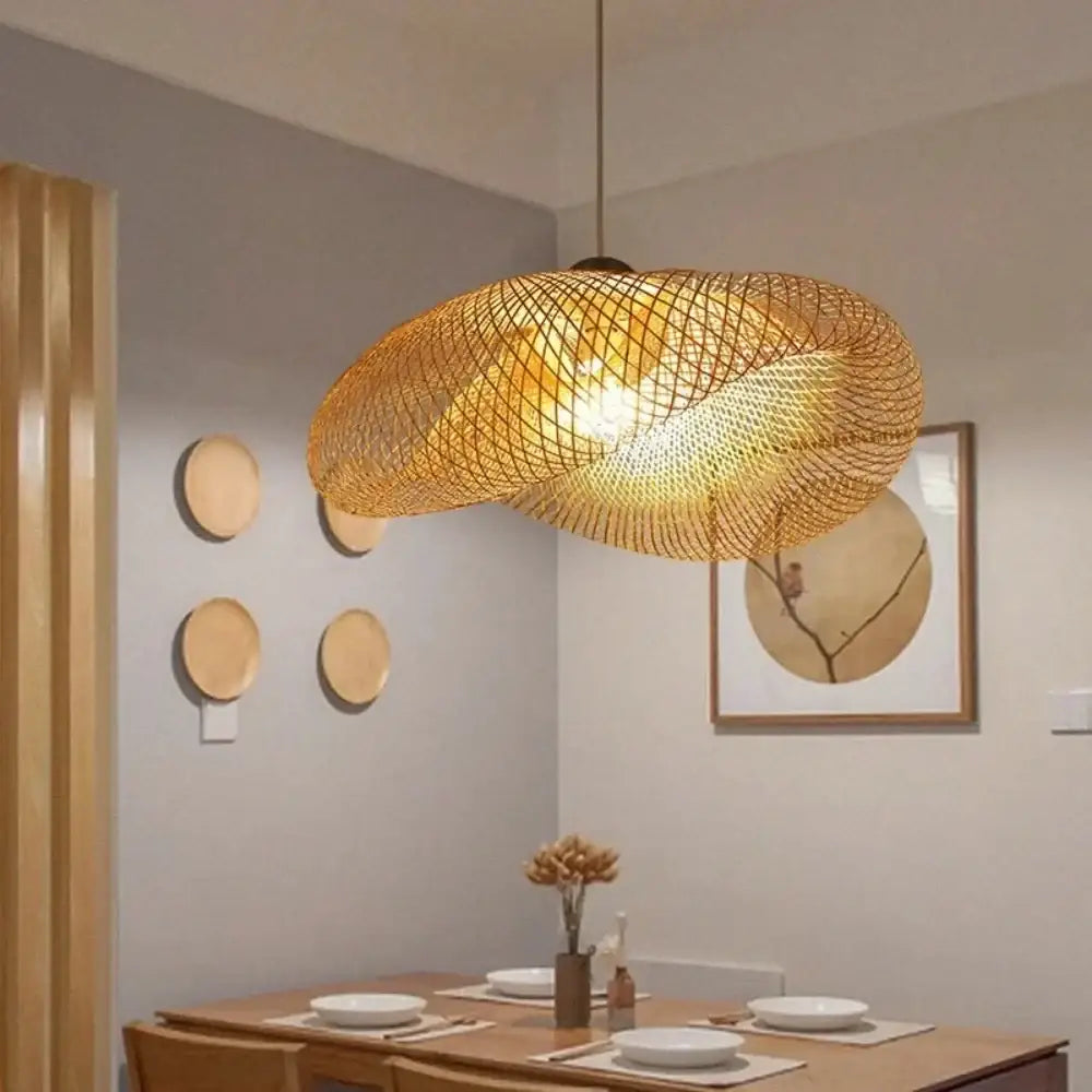 Vintage golden bamboo woven led pendant light with warm glow hanging above dining room table