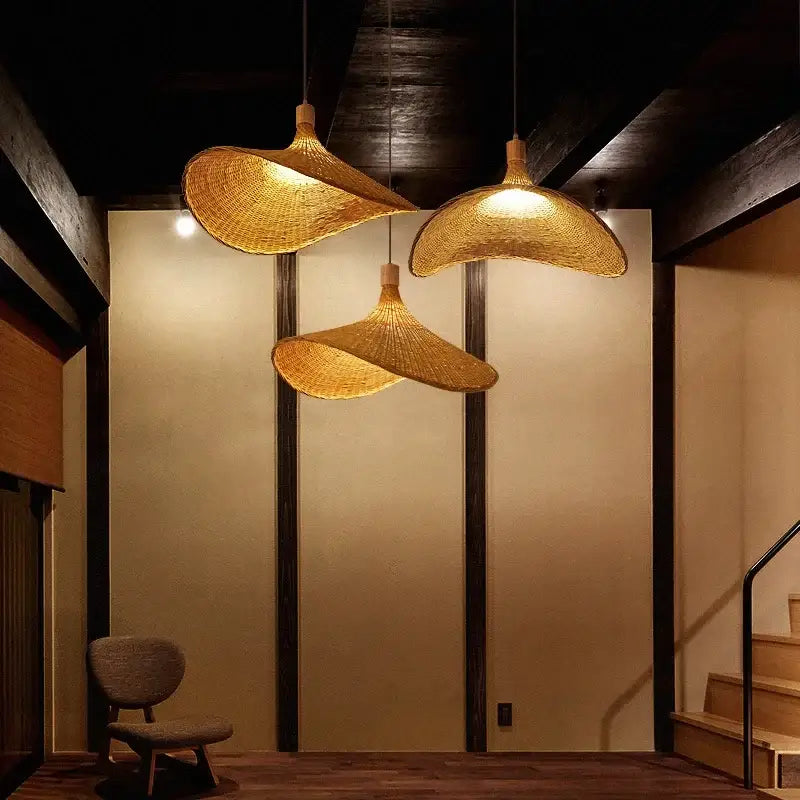 Three golden brown bamboo wicker chandelier pendant lights with natural woven design for dining room lighting