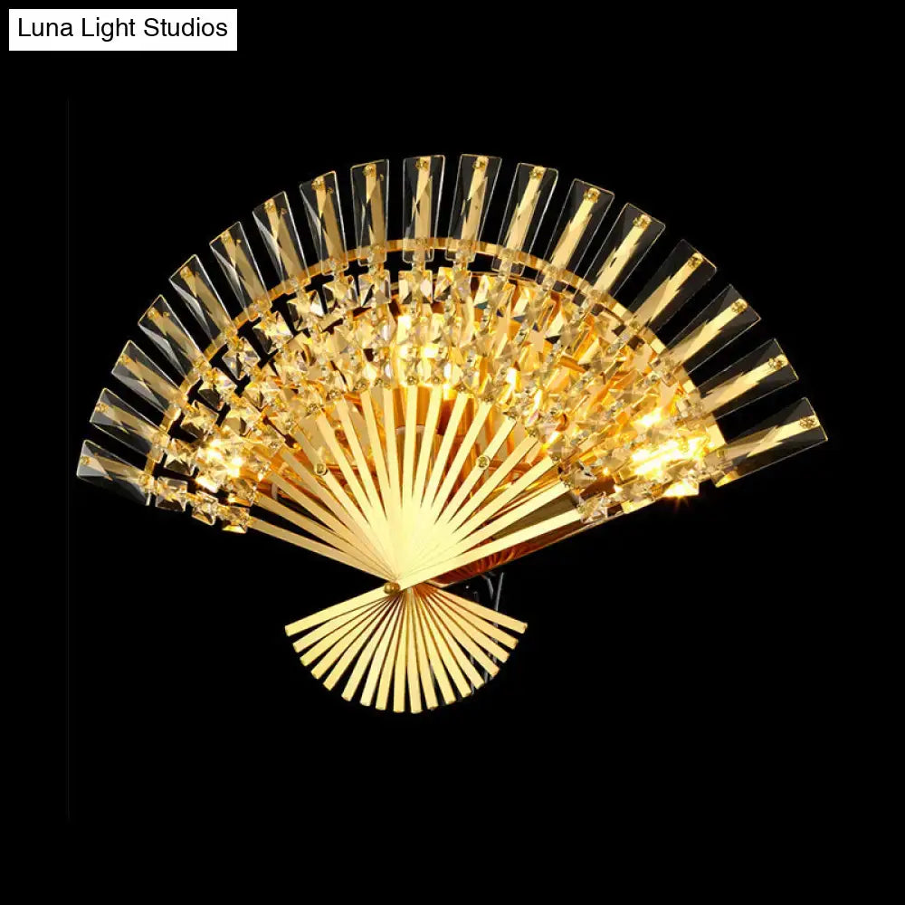 Vintage golden fan shaped crystal sconce lamp with radiant illuminated design and intricate detailing for living room wall