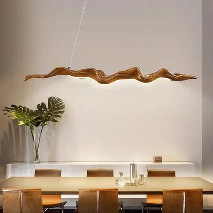 A sleek vintage golden leaf iron finish pendant light with wave-shaped design hangs above the dining table