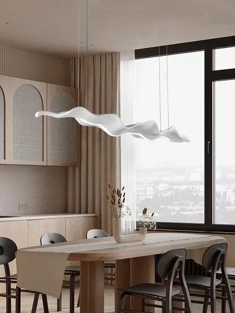 A sleek white cloud-shaped pendant light with vintage character and golden leaf iron finish for dining room decor